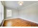 This bedroom features hardwood floors, neutral paint, bright windows, and elegant trim at 875 White Sw St, Atlanta, GA 30310