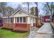 Charming brick home with red and white trim, complemented by a well-manicured lawn and inviting walkway at 875 White Sw St, Atlanta, GA 30310
