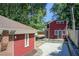 Charming home featuring a red exterior, well-maintained yard, and driveway at 875 White Sw St, Atlanta, GA 30310