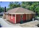 Charming home exterior with red and brick siding, well-maintained landscaping, and stone walkway at 875 White Sw St, Atlanta, GA 30310