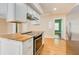 Modern kitchen with stainless steel oven, island cooktop, and butcher block countertop at 875 White Sw St, Atlanta, GA 30310