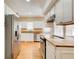 Bright kitchen featuring stainless steel appliances, white cabinets, and hardwood floors at 875 White Sw St, Atlanta, GA 30310