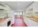 Bright kitchen featuring white appliances, butcher block counters, and red concrete floors at 875 White Sw St, Atlanta, GA 30310