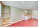 Bright kitchenette with white cabinets, butcher block countertop, and staircase in a cozy space at 875 White Sw St, Atlanta, GA 30310