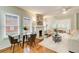 Cozy living room with a fireplace, dining area, hardwood floors, and plenty of natural light at 875 White Sw St, Atlanta, GA 30310