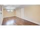 Spacious living room with gleaming hardwood floors and natural light from double windows at 875 White Sw St, Atlanta, GA 30310