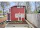 Attractive outbuilding with red siding and dual entry, set in a well-kept garden at 875 White Sw St, Atlanta, GA 30310