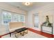 Bright sunroom features three large windows, a comfortable bench, and stylish decor at 875 White Sw St, Atlanta, GA 30310