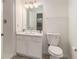 Well-lit bathroom featuring a white vanity with marble countertop and a stand-up shower at 1025 Lakeside Circle, Covington, GA 30016