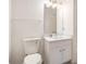 Bright bathroom featuring a modern vanity with white cabinets and a well-lit mirror at 1025 Lakeside Circle, Covington, GA 30016