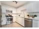 Modern kitchen featuring stainless steel appliances, quartz countertops, and white cabinets at 1025 Lakeside Circle, Covington, GA 30016
