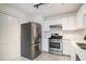 Modern kitchen featuring stainless steel appliances, quartz countertops, and white cabinets at 1025 Lakeside Circle, Covington, GA 30016