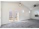 Bright, carpeted living room with vaulted ceilings and double doors leading to the backyard at 1025 Lakeside Circle, Covington, GA 30016