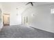 Bright, carpeted living room with vaulted ceilings and double doors leading to the backyard at 1025 Lakeside Circle, Covington, GA 30016