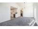 Sunlit, carpeted living room, adjacent to a modern kitchen, creating an open and inviting space at 1025 Lakeside Circle, Covington, GA 30016