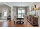 Formal dining room boasts hardwood floors, natural light, and stylish chandelier at 15 Azalea Lakes Ct, Dallas, GA 30157