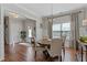 Formal dining room boasts hardwood floors, natural light, and stylish chandelier at 15 Azalea Lakes Ct, Dallas, GA 30157