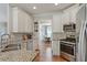 Modern kitchen featuring granite countertops, stainless steel appliances, and white cabinetry at 15 Azalea Lakes Ct, Dallas, GA 30157