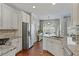 Modern kitchen featuring granite countertops, stainless steel appliances, and white cabinetry at 15 Azalea Lakes Ct, Dallas, GA 30157