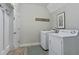 Convenient laundry room with modern washer, dryer, and storage, making chores a breeze at 15 Azalea Lakes Ct, Dallas, GA 30157