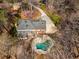 An aerial view shows a home with a pool, deck, and patio area nestled among trees at 9835 Trace Vly, Sandy Springs, GA 30350