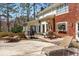 This back deck has an outdoor grill, table with umbrella, and lounge chair for relaxing at 9835 Trace Vly, Sandy Springs, GA 30350