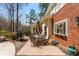 A charming back deck features a table and chairs, grill, and lovely potted plants at 9835 Trace Vly, Sandy Springs, GA 30350