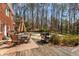 Backyard patio has dining table, grill and access to pool and wooded area at 9835 Trace Vly, Sandy Springs, GA 30350