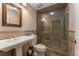 Bathroom features tiled floor, glass shower stall, and pedestal sink at 9835 Trace Vly, Sandy Springs, GA 30350
