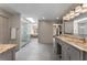 A serene bathroom showcases a glass-enclosed shower, a separate soaking tub, and stylish vanities at 9835 Trace Vly, Sandy Springs, GA 30350