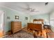 Cozy bedroom features hardwood floors, a ceiling fan, a wooden bed frame, an area rug and natural light at 9835 Trace Vly, Sandy Springs, GA 30350