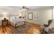 Bedroom with hardwood floors, chair, area rug and natural light coming through shuttered windows at 9835 Trace Vly, Sandy Springs, GA 30350