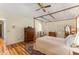 Charming bedroom boasts hardwood floors, a ceiling fan and a view through a doorway into another room at 9835 Trace Vly, Sandy Springs, GA 30350