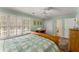 Bedroom with a large window, a ceiling fan, hardwood floors and a classic bed frame at 9835 Trace Vly, Sandy Springs, GA 30350