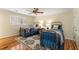 Bright bedroom featuring two beds, hardwood floors, and natural lighting through shuttered windows at 9835 Trace Vly, Sandy Springs, GA 30350