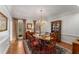 Formal dining room with hardwood floors, elegant chandelier, and large windows with decorative drapes at 9835 Trace Vly, Sandy Springs, GA 30350