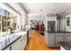 Open-concept kitchen with an island, stainless steel appliances, a farmhouse sink, and hardwood floors at 9835 Trace Vly, Sandy Springs, GA 30350