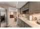 Kitchen with stainless steel refrigerator, tiled backsplash, and direct view to living area at 9835 Trace Vly, Sandy Springs, GA 30350
