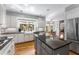 Modern kitchen with white cabinets, stainless steel appliances, an island, hardwood floors and granite countertops at 9835 Trace Vly, Sandy Springs, GA 30350