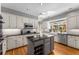 Bright kitchen with white cabinets, stainless steel appliances, an island, hardwood floors and granite countertops at 9835 Trace Vly, Sandy Springs, GA 30350