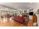 Spacious living room with hardwood floors, fireplace, built-ins, and a wall of windows showcasing outdoor views at 9835 Trace Vly, Sandy Springs, GA 30350