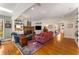 Open-concept living room with a fireplace, hardwood floors, and lots of natural light at 9835 Trace Vly, Sandy Springs, GA 30350