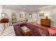 Cozy living room featuring hardwood floors, classic furnishings, crown molding and large windows at 9835 Trace Vly, Sandy Springs, GA 30350