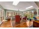 Bright sunroom with skylights, large windows, and views of the wooded property at 9835 Trace Vly, Sandy Springs, GA 30350