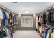 Spacious walk-in closet with custom shelving and storage, perfect for organization and style at 9835 Trace Vly, Sandy Springs, GA 30350
