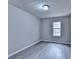 Minimalist bedroom with grey walls, wood-style floors, and a window at 2892 Norfair Ne Loop, Lithonia, GA 30038