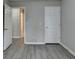 Empty bedroom with grey walls, wood-style floors, and open doorway at 2892 Norfair Ne Loop, Lithonia, GA 30038