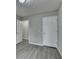 Empty bedroom with grey walls, wood-style floors, and two doors at 2892 Norfair Ne Loop, Lithonia, GA 30038