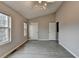 Light-filled bedroom featuring neutral walls and gray wood floors at 2892 Norfair Ne Loop, Lithonia, GA 30038