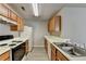 Well-equipped kitchen featuring white appliances, light wood cabinets, and sink at 2892 Norfair Ne Loop, Lithonia, GA 30038